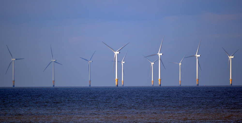 photo of floating wind turbines in the ocean